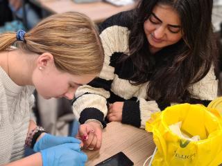 two students practicing clinical skills two students practicing clinical skills